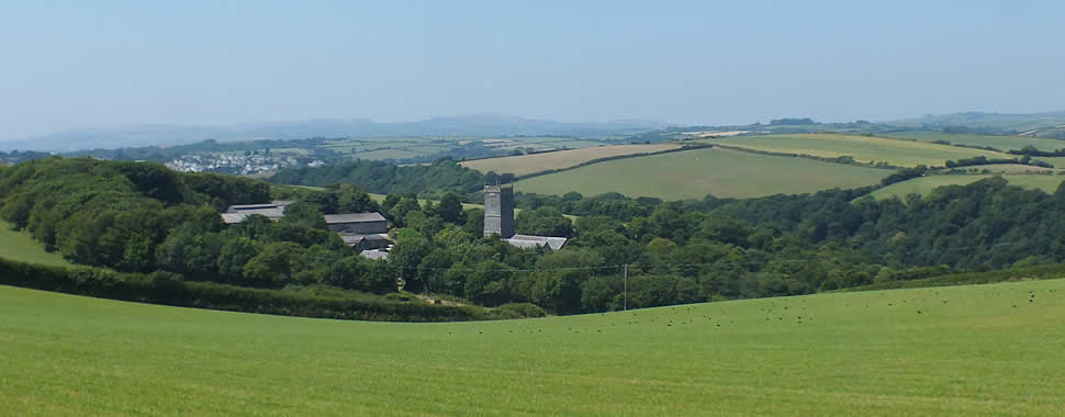 St Wyllow Church lies inland on the slopes of a wooded valley with walks down to Pont Pill