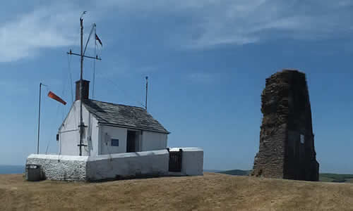 The NCI Polruan Lookout Station alongside St Saviours Chapel ruins stand on the hill high above Polruan